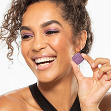 Woman wearing and holding LimeLife Perfect Eyeshadow.